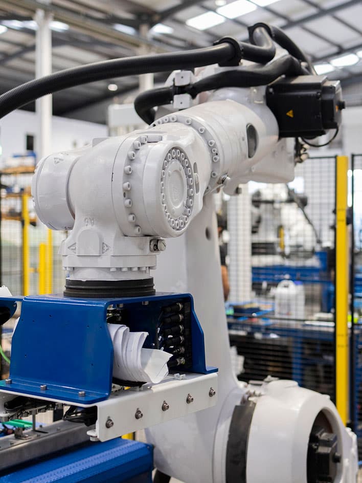 Collaborative robot placing packages in a warehouse with safety barriers